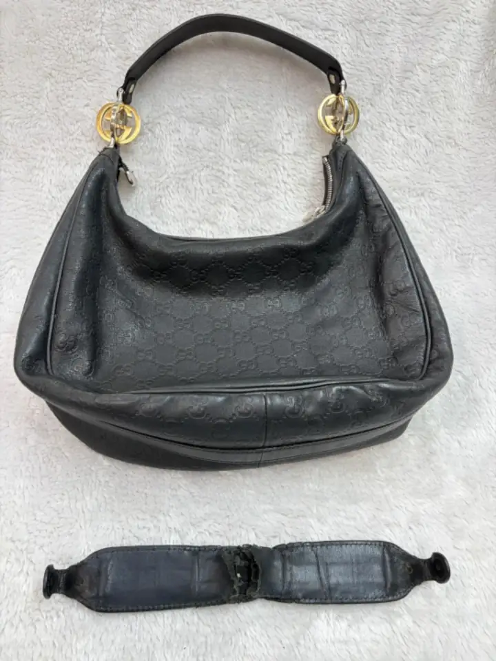 Dark color bag strap repair 1 A Black leather hand bag had its old leather strap replaced.