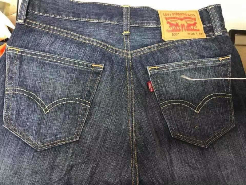 Alteration of dark denim jeans by re-stitching.