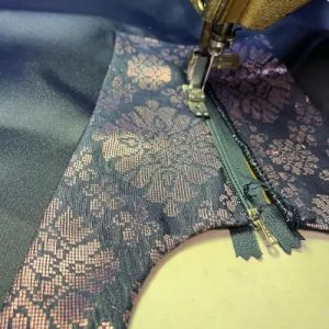 A zipper was sewn on a custom blue Malay dress.