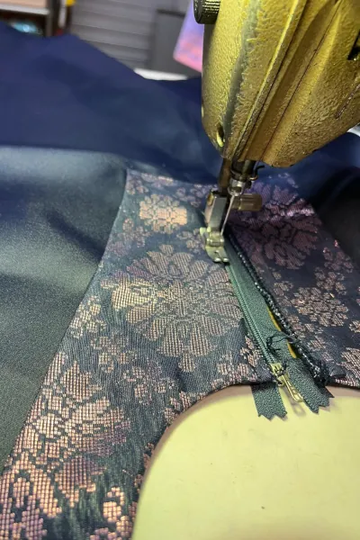 Custom sewing of a zipper on a blue dress for a Malay customer.
