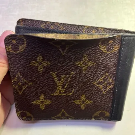 A branded leather wallet was worn around the edges.