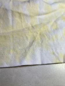 The resewn edge of the tshirt with double stitching.