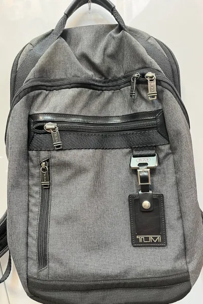 Repair of backing of a branded backpack.