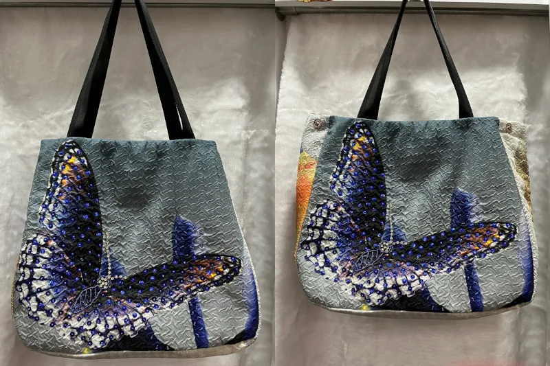 Fabric of a dress was remake into a handbag with a picture of a butterfly. The left shows the bag with side button closed and right shows the bag fully opened.