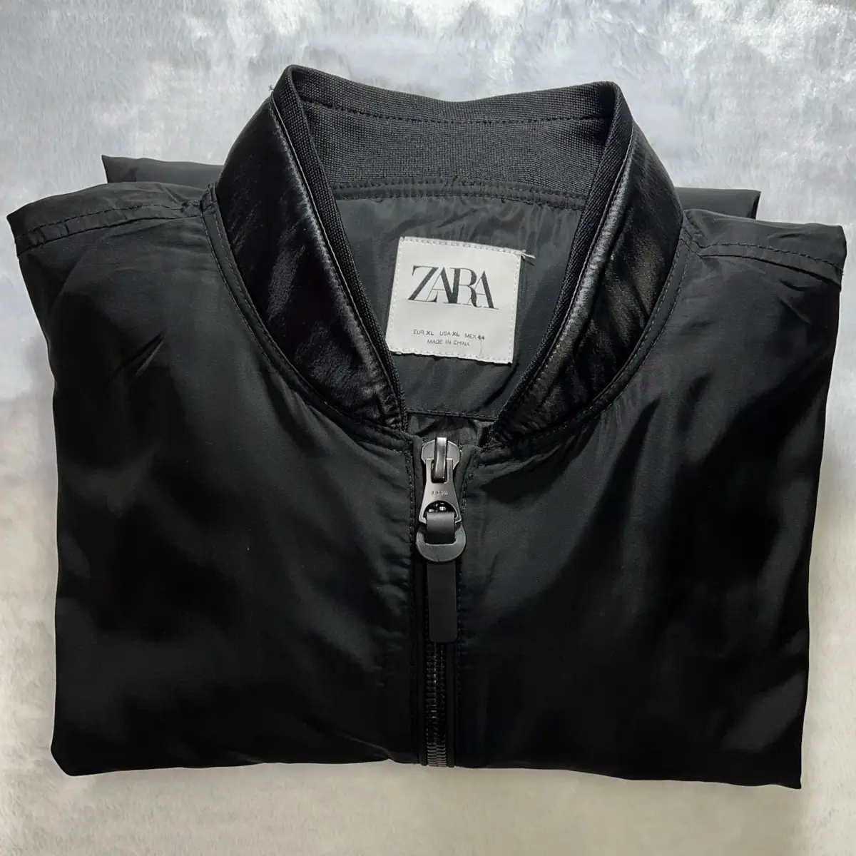 Picture shows a restored black Zara jacket with replacement faux leather material sewn on the the jacket.