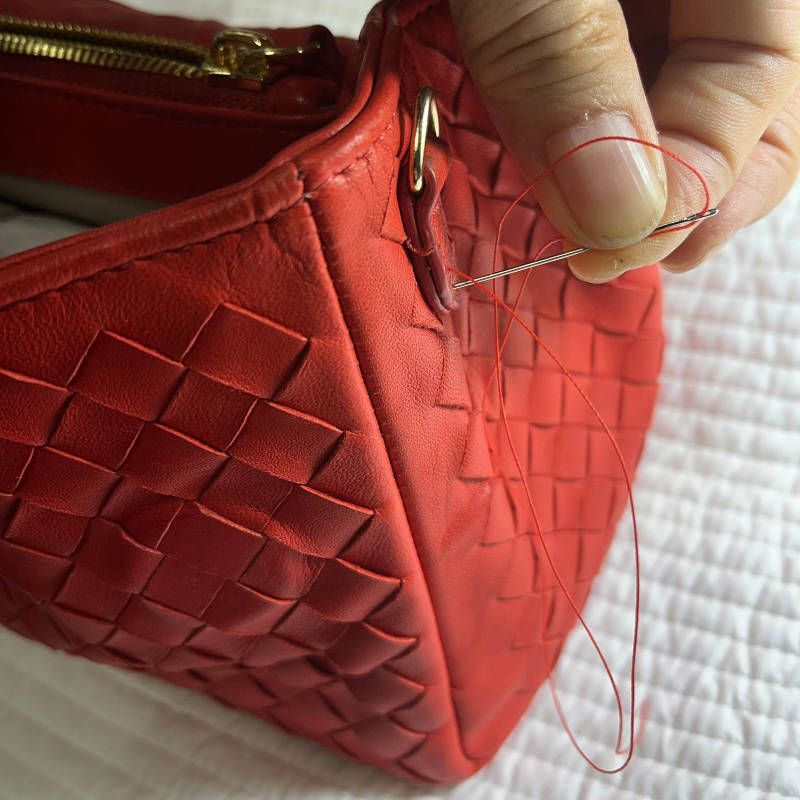 Sewing of red color leather handbag feature image.