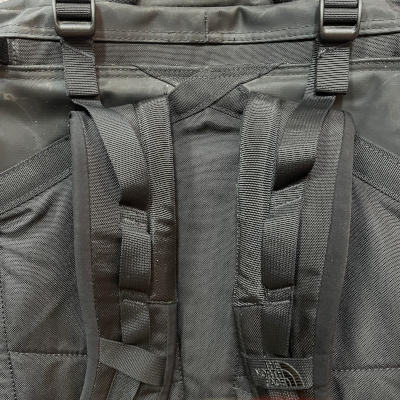Feature image showing repaired shoulder straps on a black North Face backpack.
