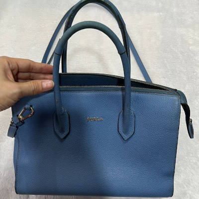 Blue color Furla handbag after cleaning service.