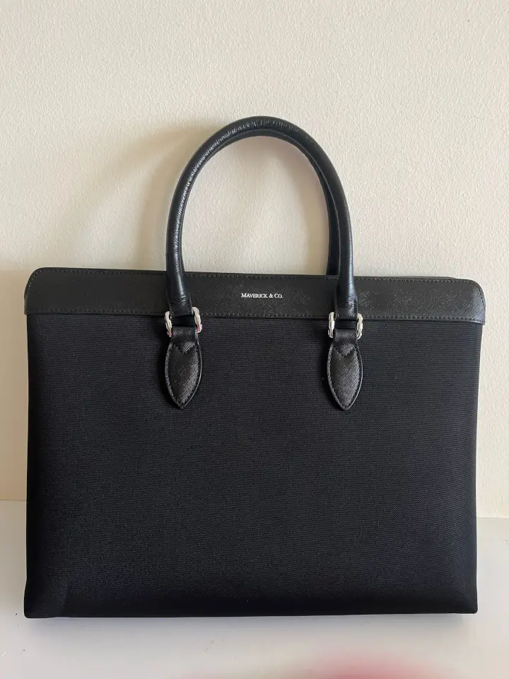 Repaired black leather Maverick & Co leather handbag.