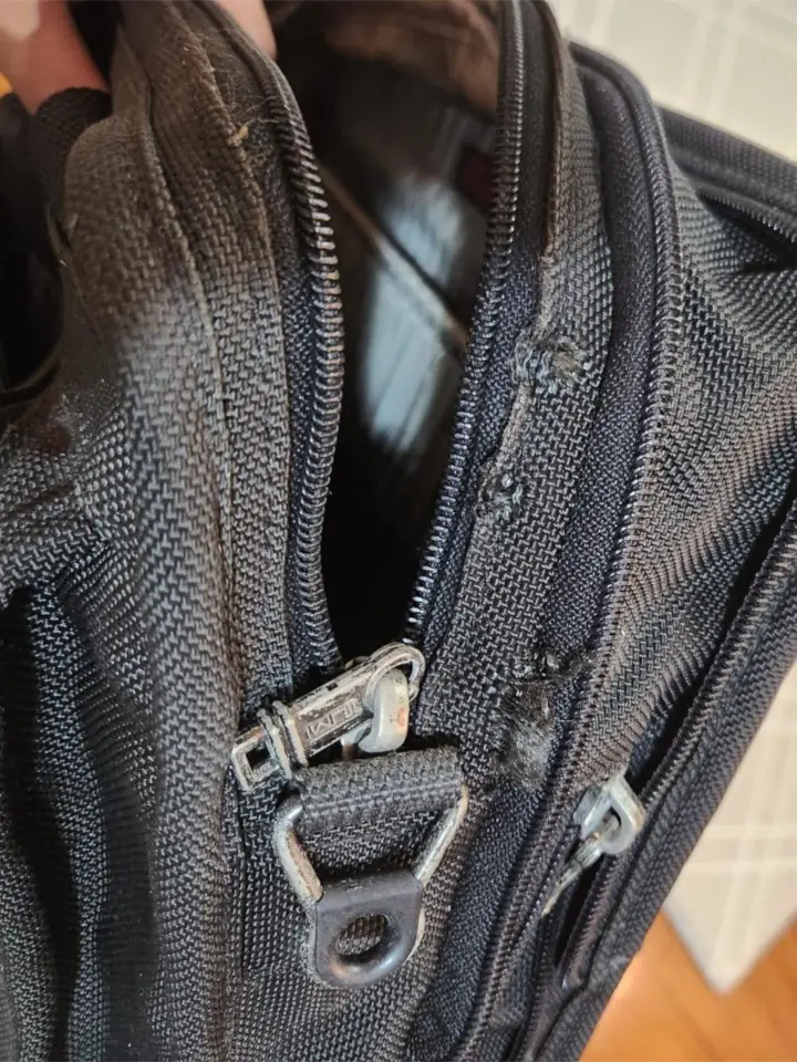 Worn out TUMI briefcase was sent over for repair a the zipper area. View from the other side.