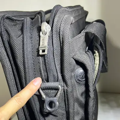 Repair of TUMI briefcase where the cloth of the zipper was replaced.